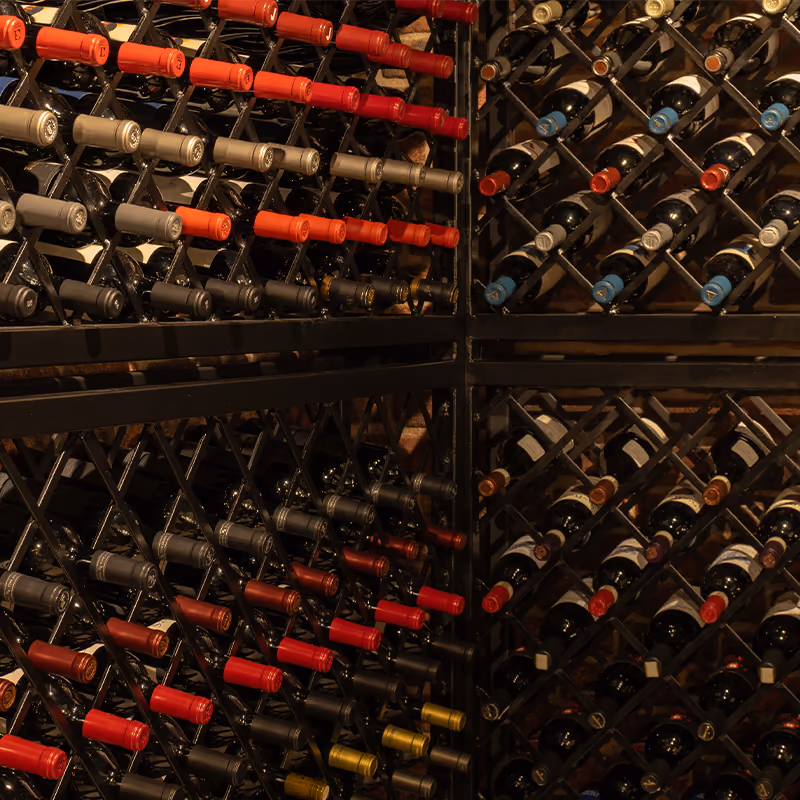 Bottles racked to the ceiling along the cellar wall
