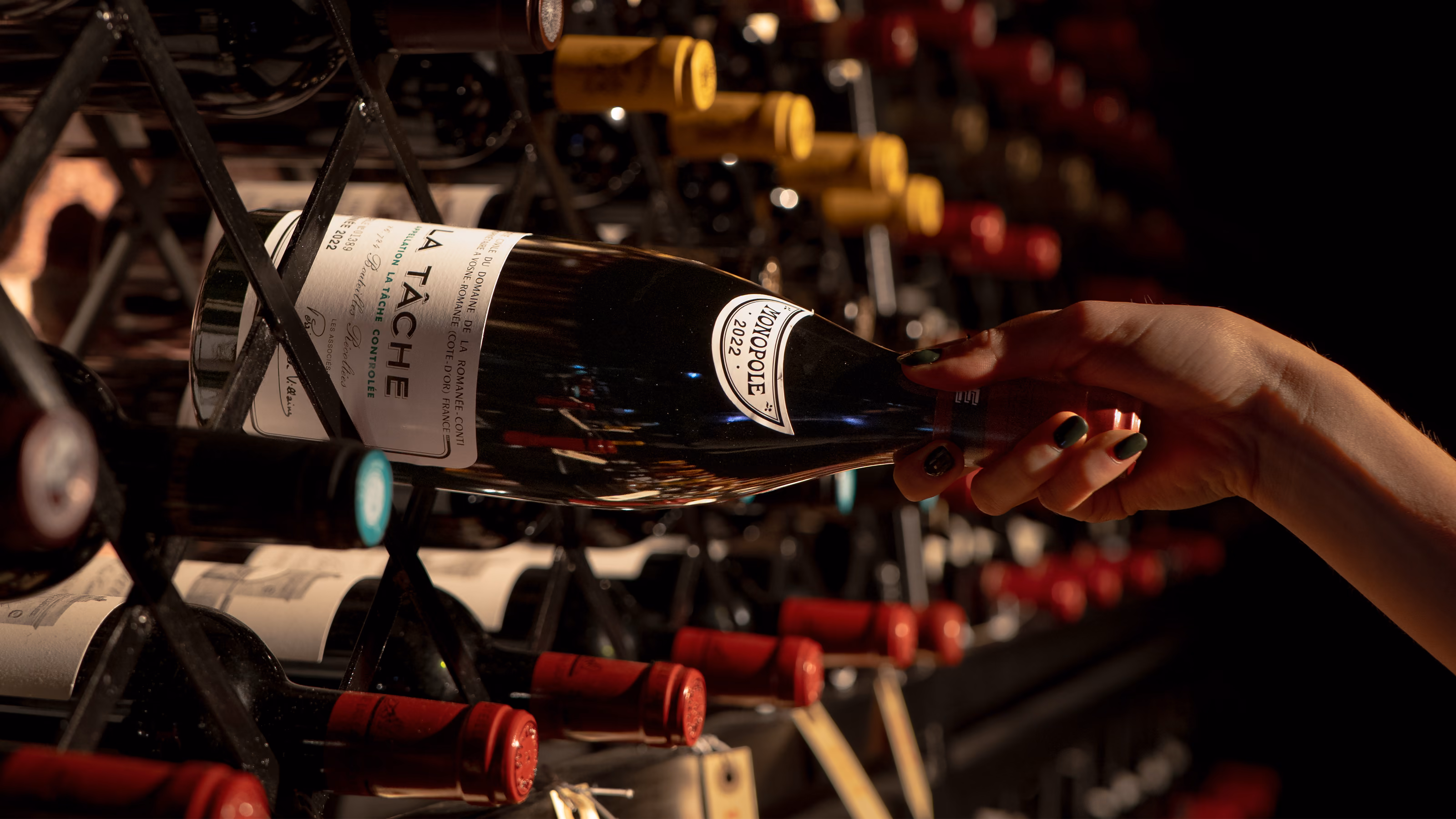A bottle of La Tache drawn from the cellar rack by hand