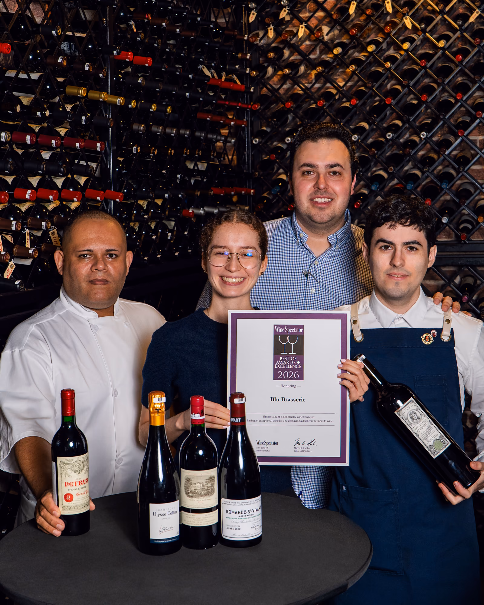 The Blu Brasserie team in the cellar with the 2026 Wine Spectator award